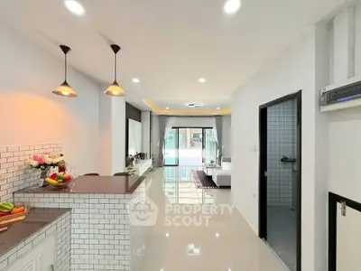 Modern open-plan kitchen with sleek design and bright living area