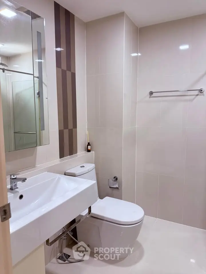 Modern bathroom with sleek fixtures and neutral tile design