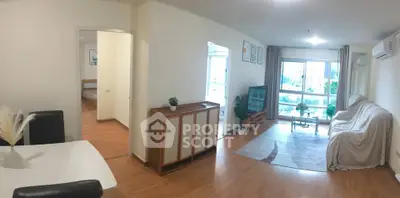 Spacious living room with modern decor and city view, perfect for urban living.