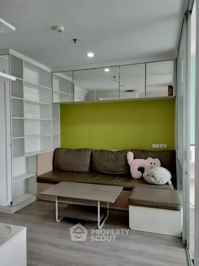 Modern living room with built-in shelves and cozy seating area in a stylish apartment.