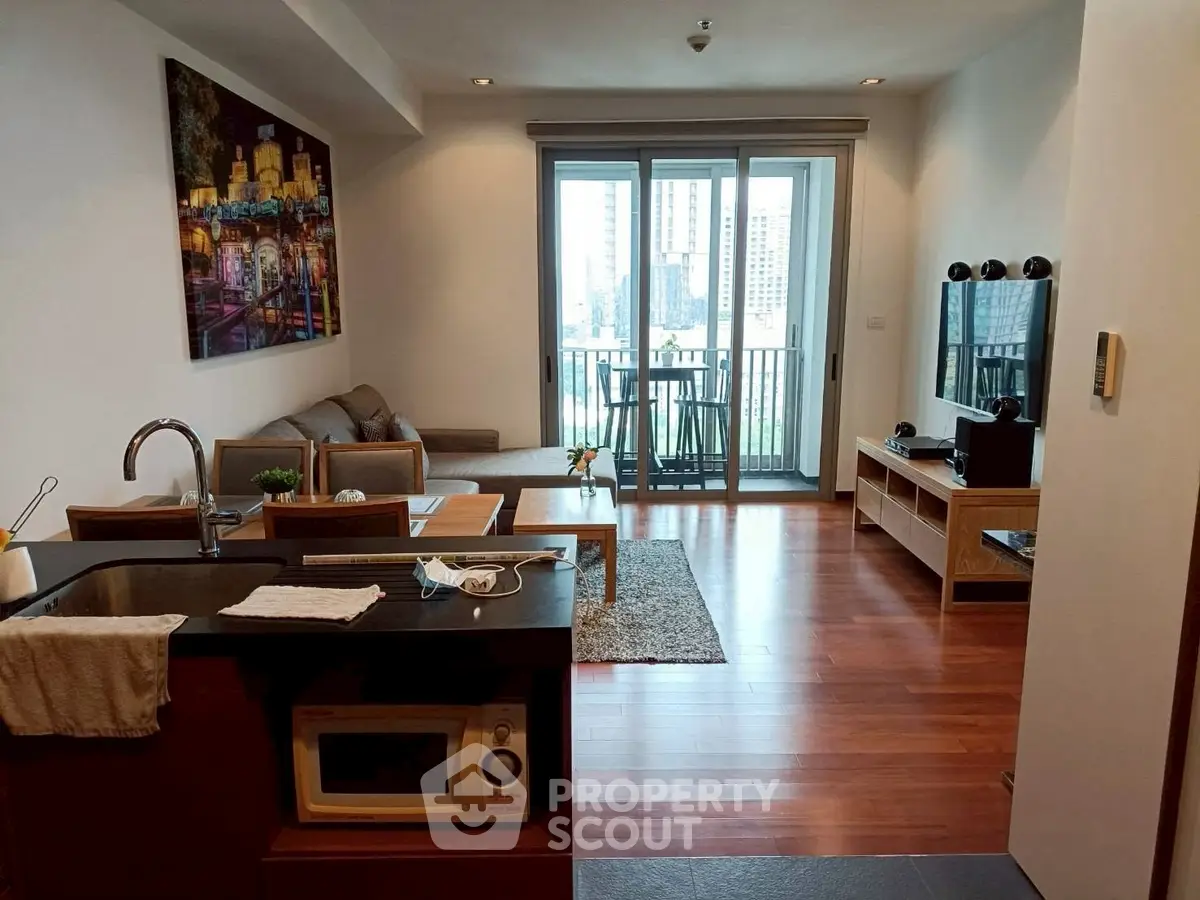 Modern open-plan living room with balcony and city view