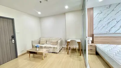 Modern studio apartment with cozy living area and stylish decor