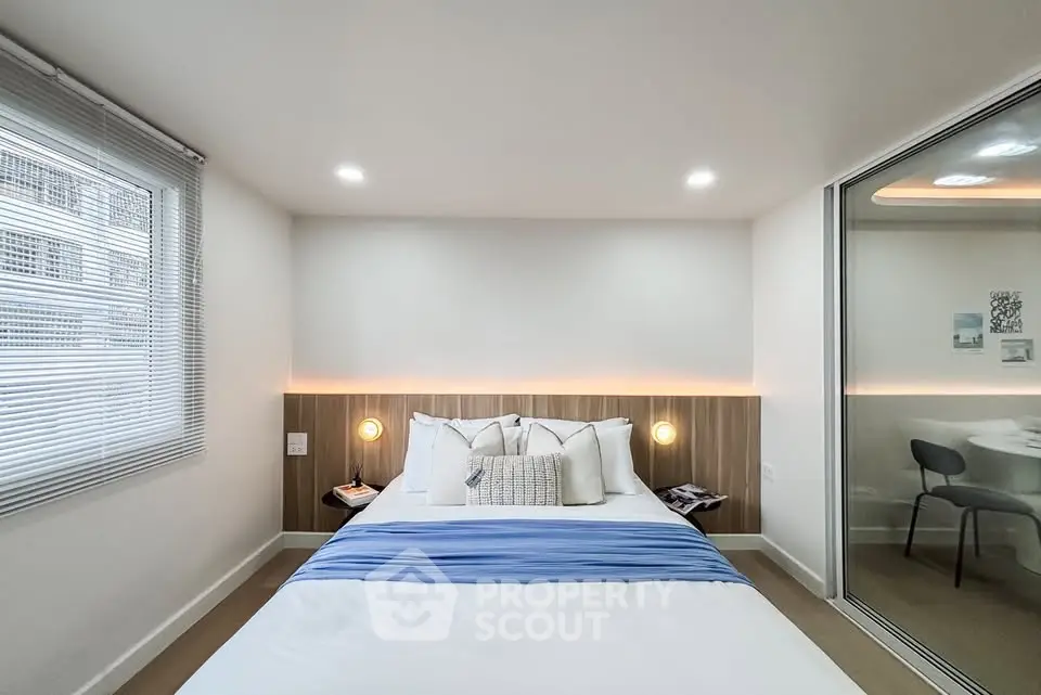 Modern bedroom with stylish decor and ample natural light