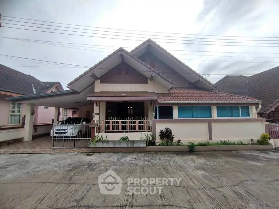 Charming suburban house with a spacious driveway and classic gable roof design, perfect for family living.