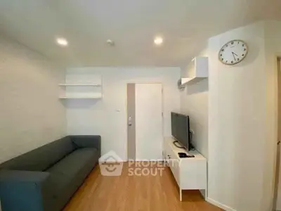 Modern living room with sleek furniture and wall-mounted TV, perfect for cozy relaxation.