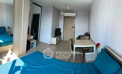 Modern studio apartment with sleek design and natural light, featuring a cozy living area and stylish furnishings.
