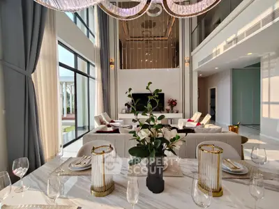 Luxurious open-plan living room with elegant decor and high ceilings