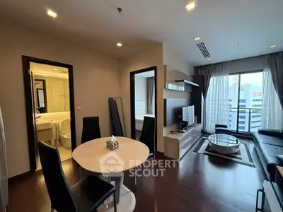 Modern living room with dining area and balcony in a stylish apartment
