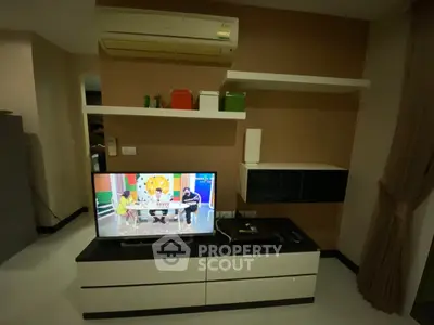 Modern living room with wall-mounted air conditioner and sleek TV unit
