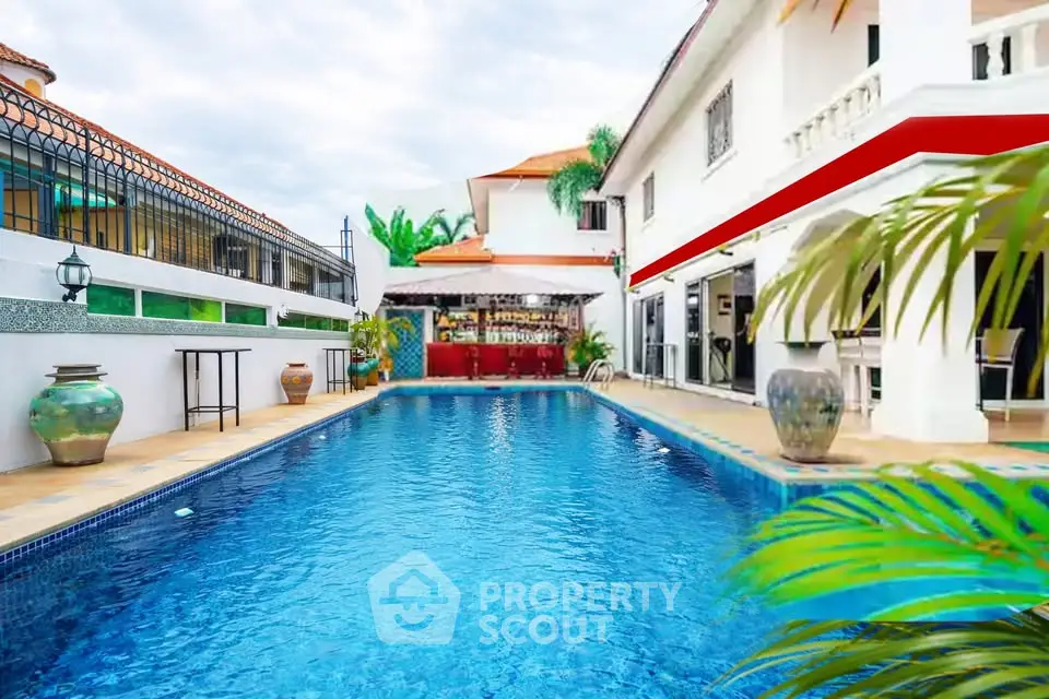 Luxurious villa with stunning outdoor pool and elegant patio area, perfect for relaxation and entertainment.