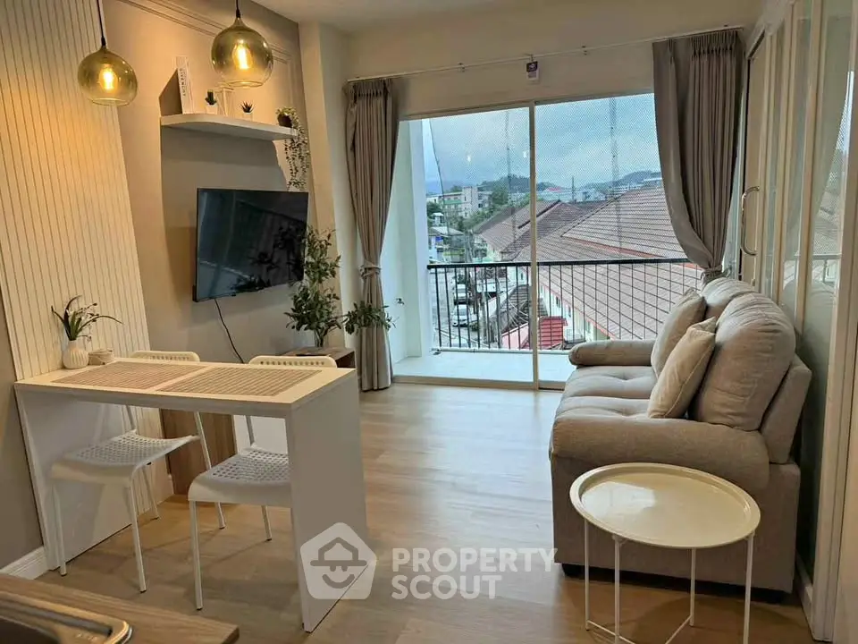 Modern living room with cozy sofa, dining area, and balcony view in stylish apartment.