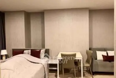Cozy bedroom with modern decor and small dining area, perfect for urban living.