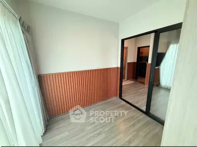 Modern interior with wooden paneling and sliding glass doors, perfect for a cozy living space.