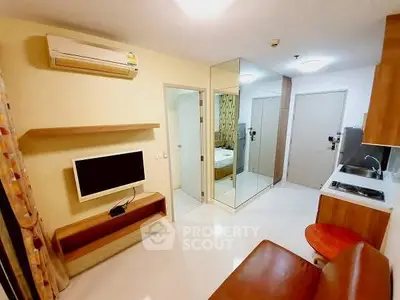 Modern studio apartment with sleek kitchen and cozy living area