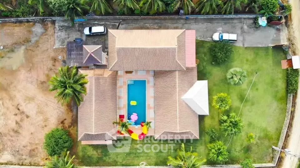 Stunning aerial view of a luxurious villa with private pool and lush garden.