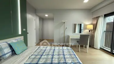 Modern bedroom with stylish decor, large window, and cozy lighting in a contemporary apartment.