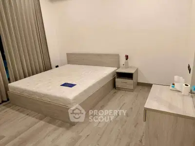 Modern minimalist bedroom with wooden flooring and neutral decor