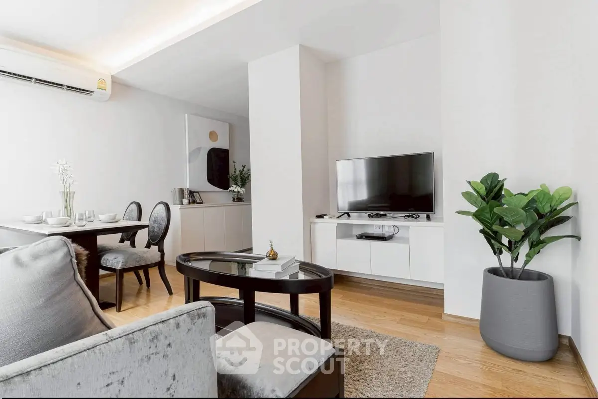 Modern living room with sleek furniture and elegant decor in a stylish apartment.