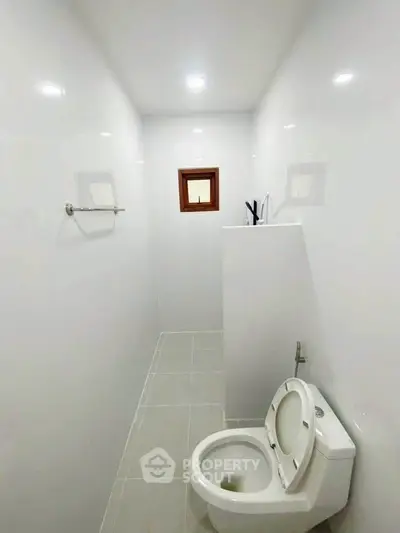 Minimalist bathroom with white tiles and modern toilet design