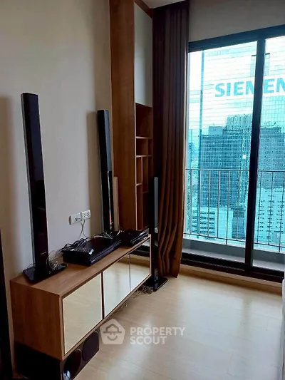 Modern living room with sleek entertainment setup and city view balcony.