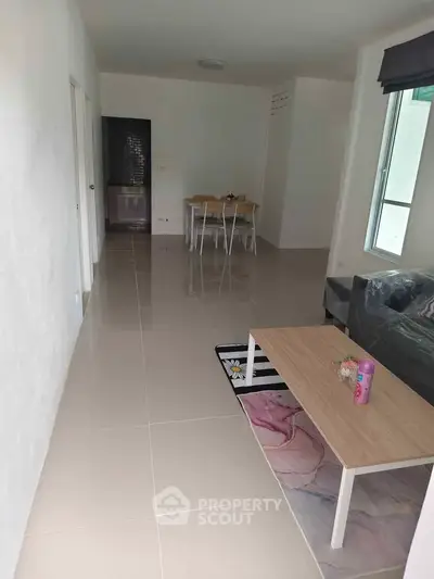Spacious living room with modern furniture and dining area, perfect for family gatherings.