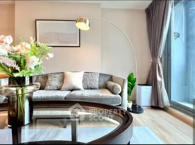 Modern living room with stylish decor, featuring a cozy sofa, elegant floor lamp, and large window view.