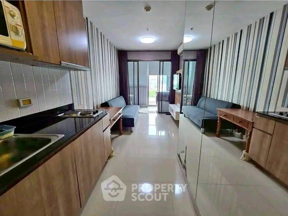 Modern living room with sleek kitchen and balcony view in stylish apartment