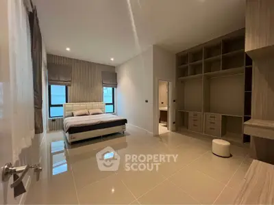 Spacious modern bedroom with built-in storage and ensuite bathroom