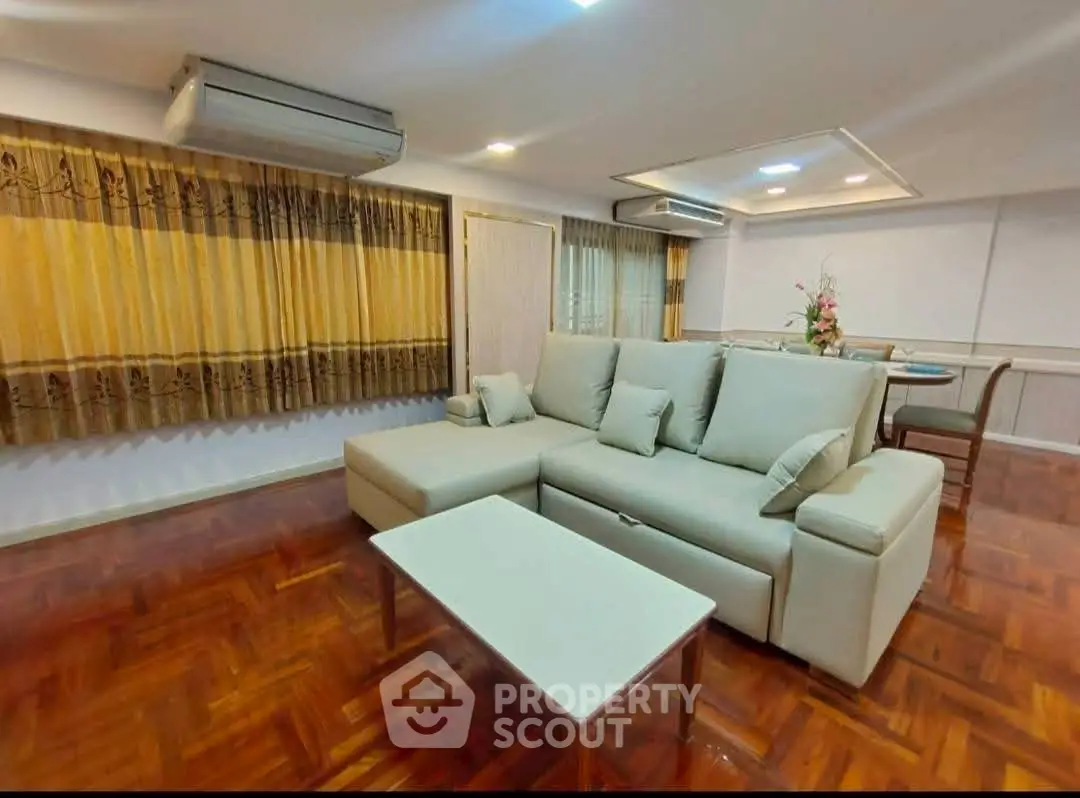 Spacious living room with elegant sofa and wooden flooring