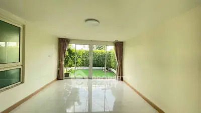 Spacious living room with garden view and large windows in modern home