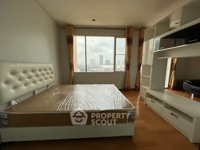 Spacious bedroom with city view and modern furnishings