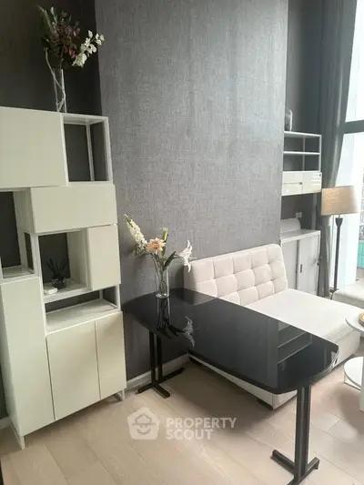 Modern living room with sleek furniture and large window for natural light