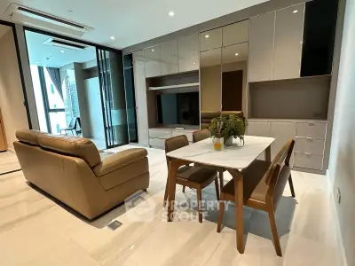 Modern living room with sleek furniture and dining area in a stylish apartment.