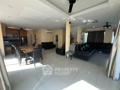 Spacious open-plan living room with modern furniture and dining area