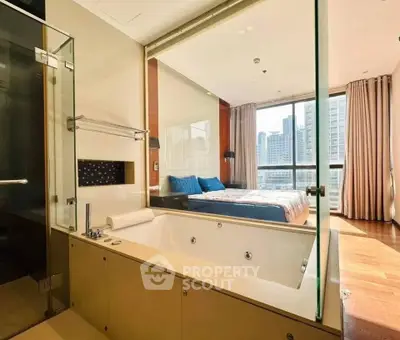 Luxurious bedroom with ensuite bathroom featuring a modern bathtub and city view.
