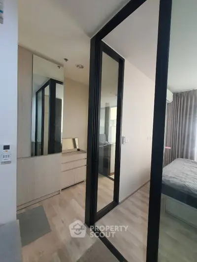 Modern bedroom with glass partition and wooden flooring