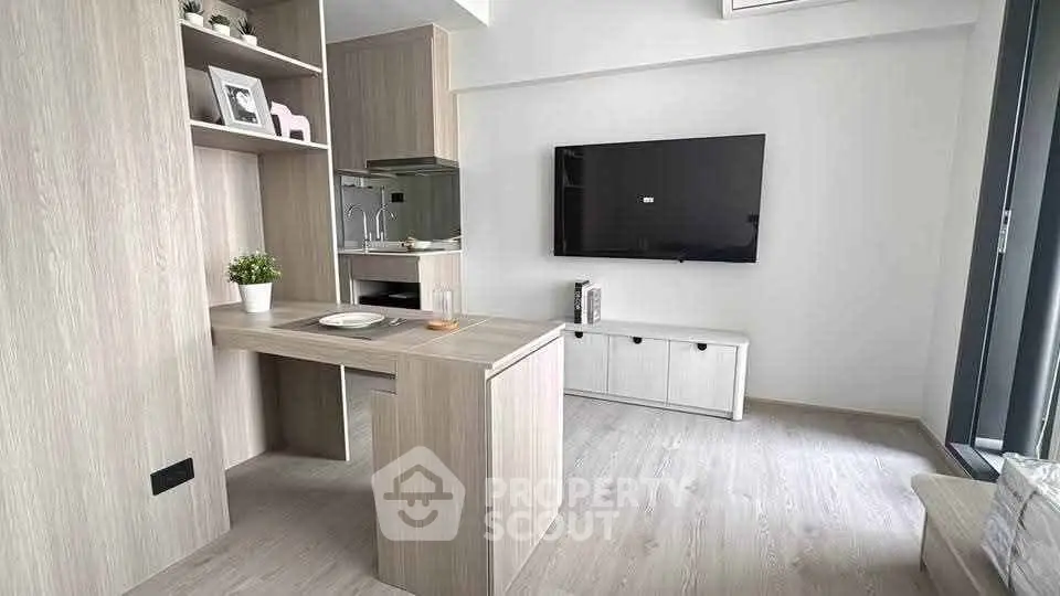Modern living room with sleek wooden furniture and wall-mounted TV in a stylish apartment.
