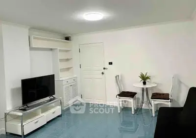 Cozy living room with modern TV setup and stylish furniture in a bright, inviting space.