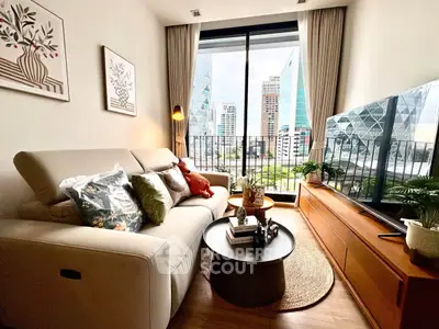 Modern living room with city view, stylish decor, and cozy seating area.
