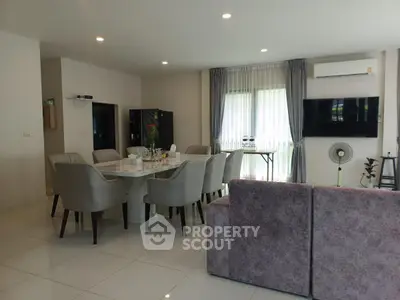 Spacious modern living room with elegant dining area and cozy seating.