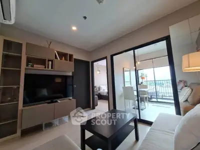 Modern living room with sleek furniture and balcony view in a stylish apartment.