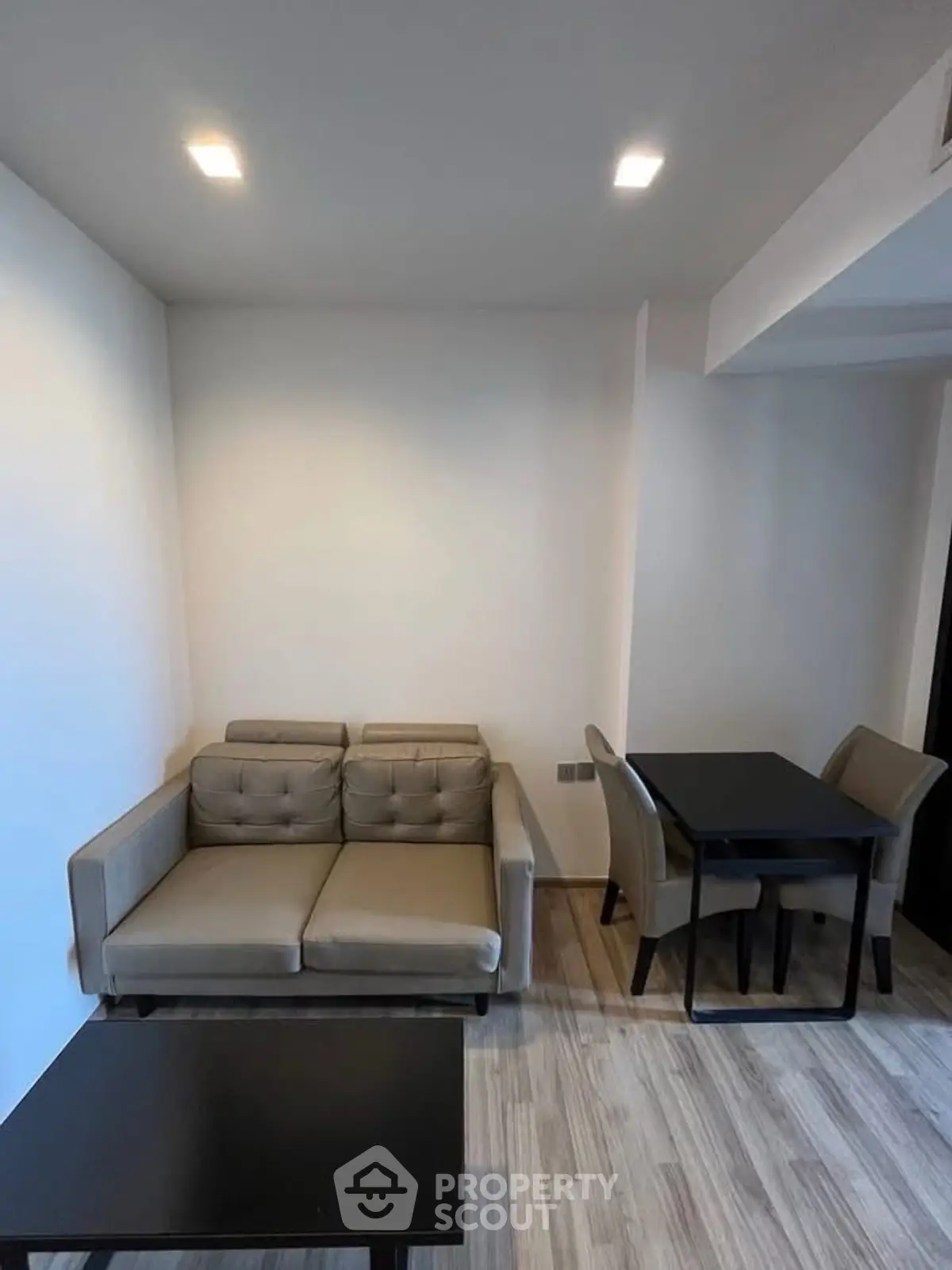 Modern living room with cozy sofa and dining table in a stylish apartment.