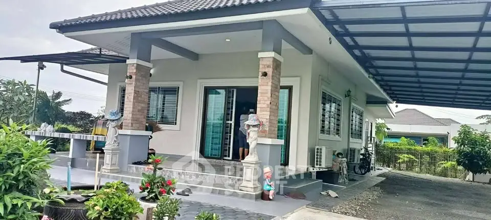 Charming single-story home with covered carport and lush garden, perfect for family living.