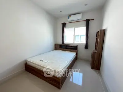 Spacious bedroom with modern furnishings and natural light