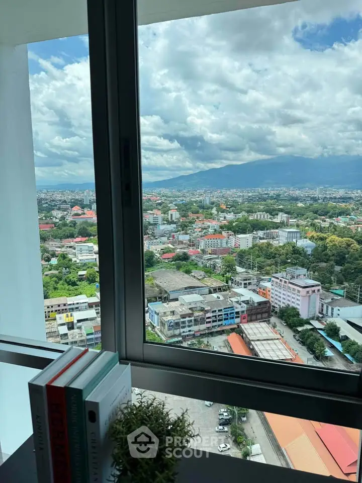 Stunning cityscape view from high-rise apartment window with lush greenery and urban skyline.