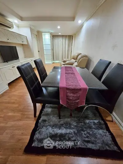 Elegant living room with dining area, featuring modern furniture and cozy ambiance.