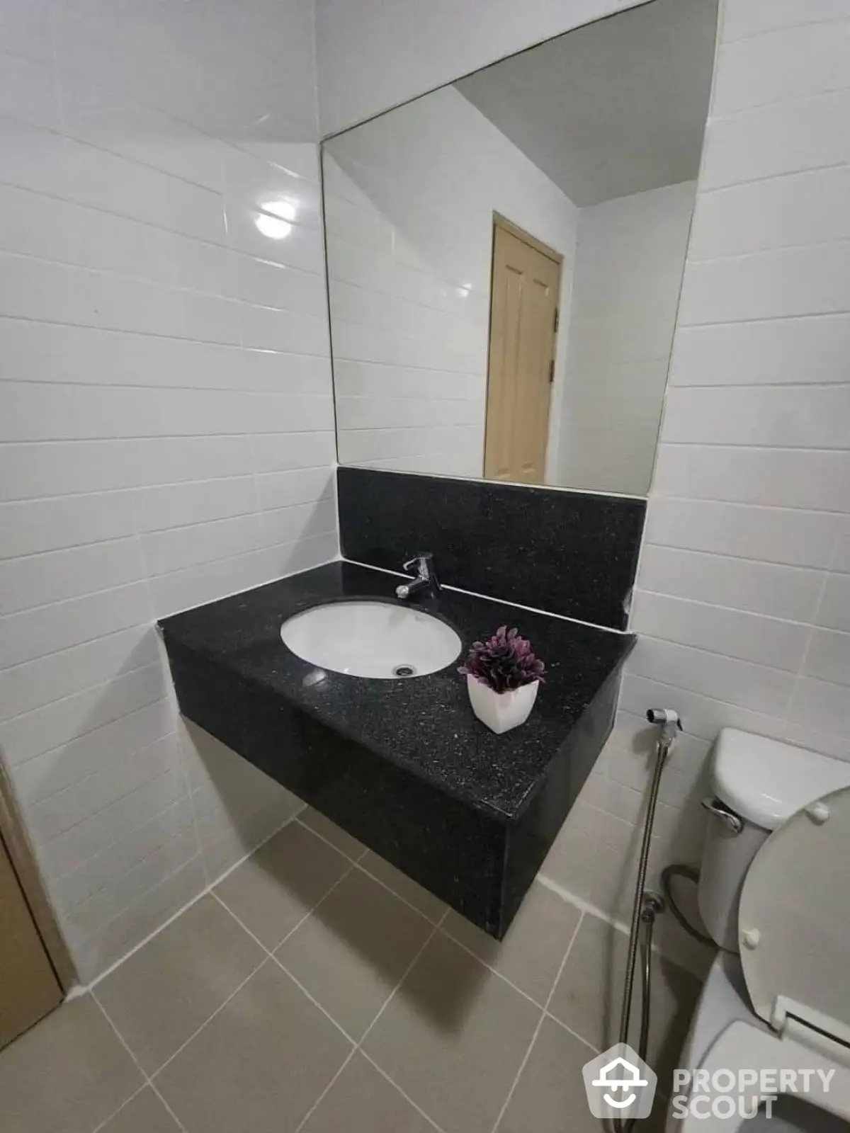 Modern bathroom with sleek black countertop and large mirror