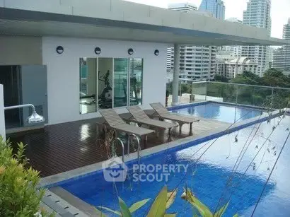 Luxurious rooftop pool with city skyline view and modern amenities.