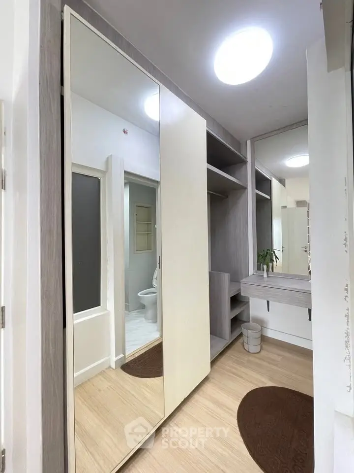 Modern bathroom with large mirror and sleek storage solutions