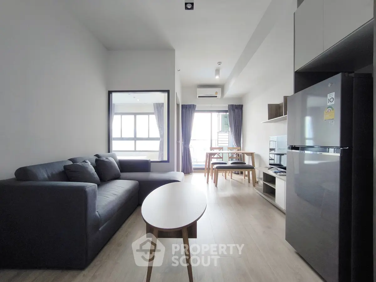Modern living room with sleek furniture and natural light in a stylish apartment.